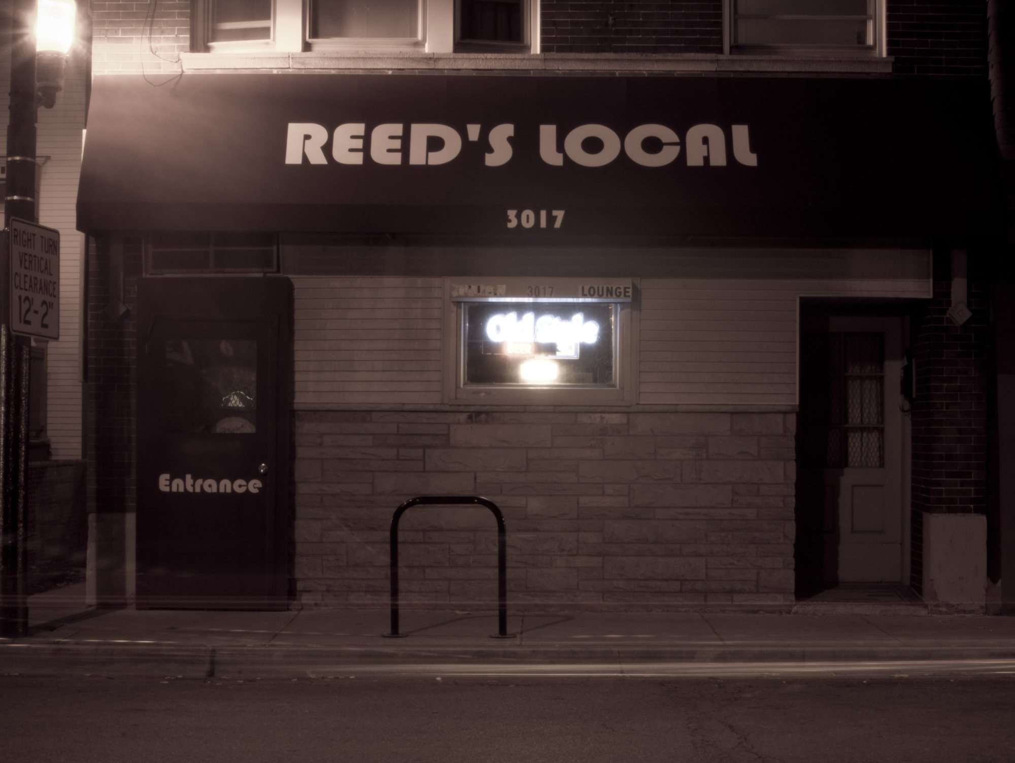 The Reed's Local storefront at night