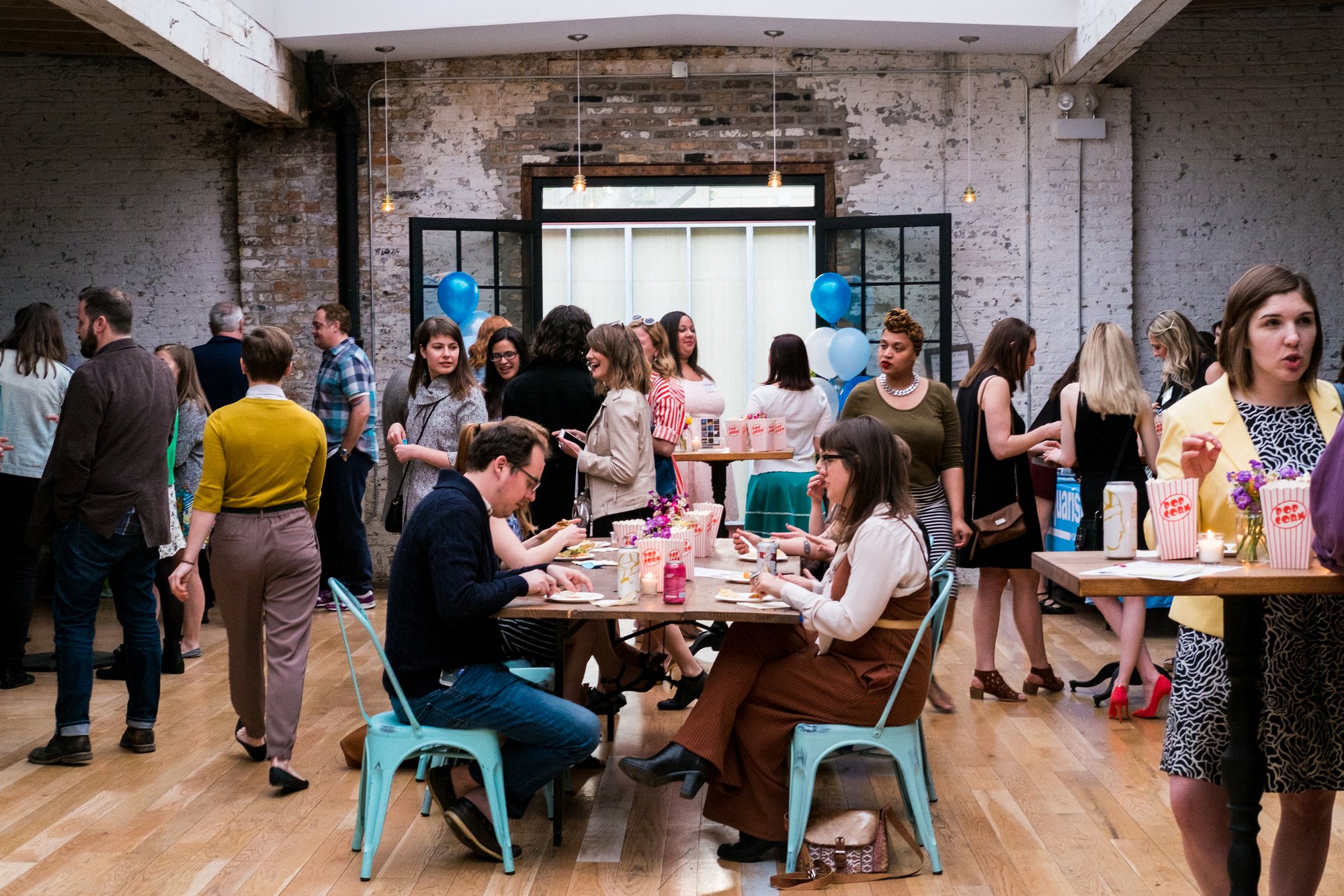 Guests at the 2018 LoganSquarist fundraiser in a brick-walled event space