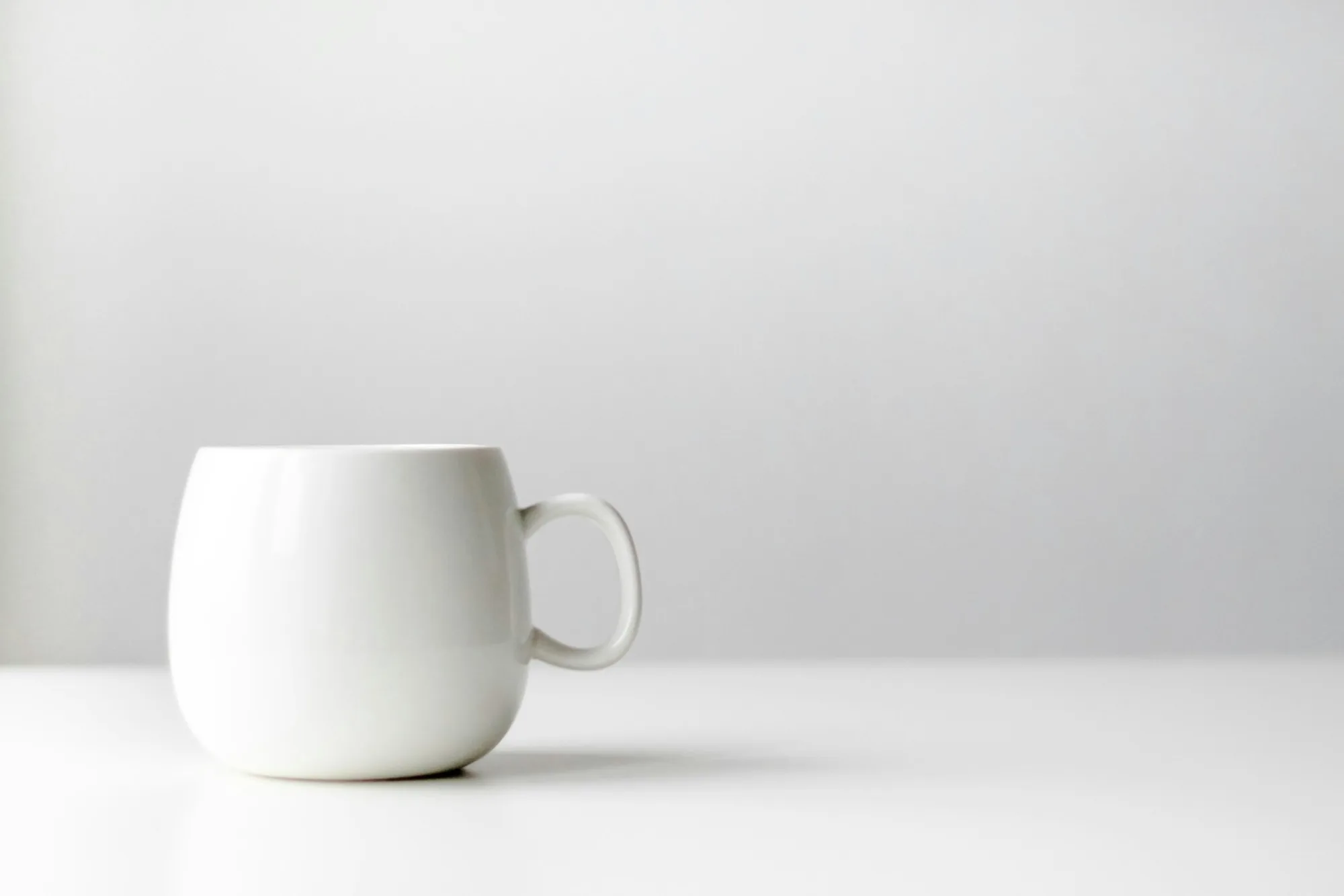 White mug on a white desk and white background