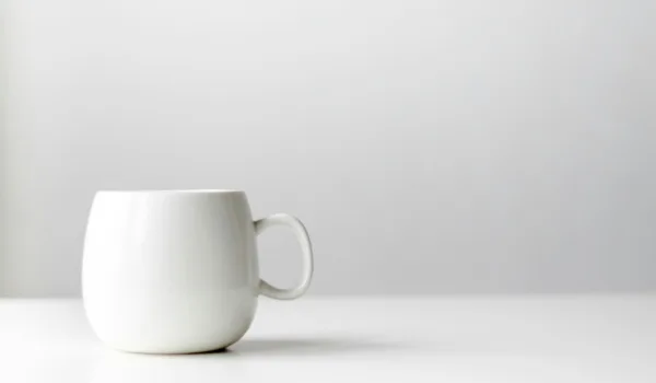 White mug on a white desk and white background
