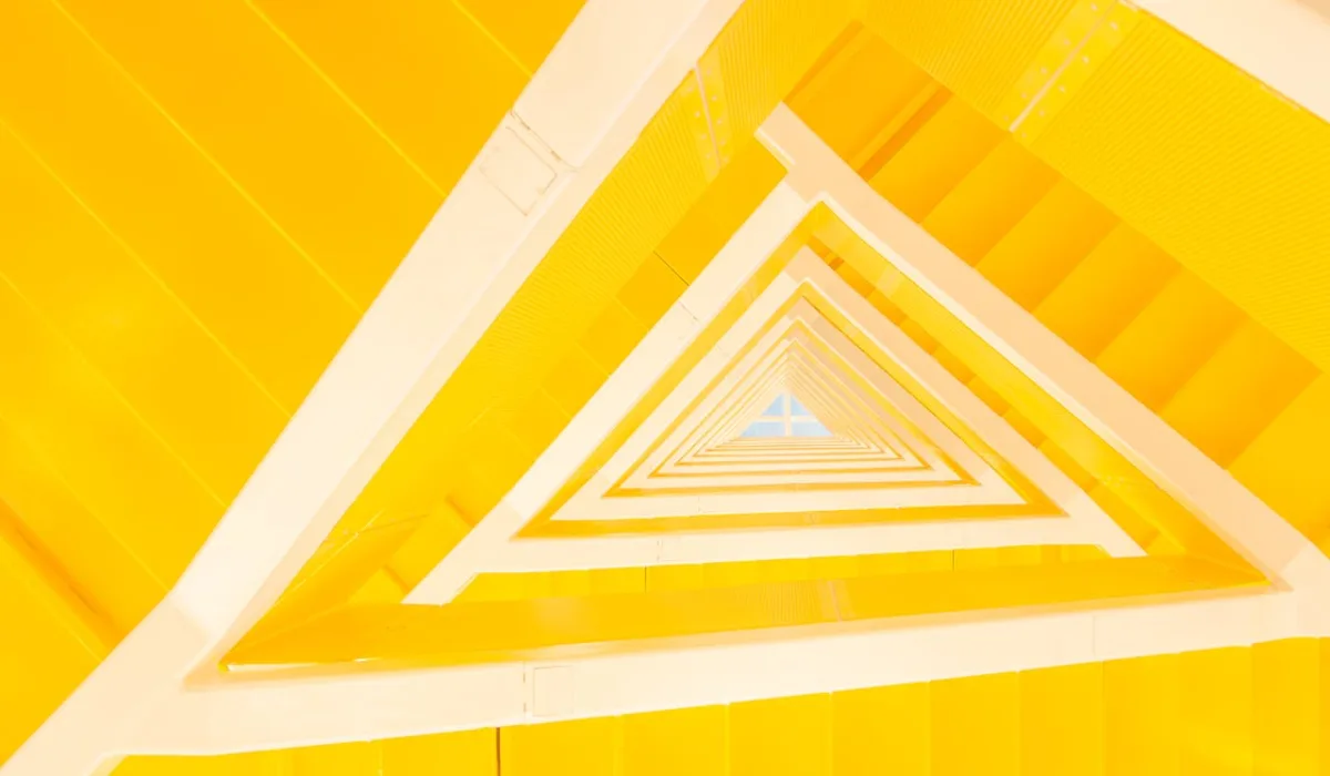 Abstract geometric structure with repeating triangular forms, symbolizing alignment, systems, and coordinated decision-making.